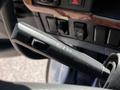 Close-up of the gear shift lever of a 2005 Volvo VND 122 featuring various settings including off and drive indicators