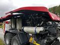 A 2020 Pottinger Impress with a red roof and various components visible including wrapped materials and mechanical parts in a compact design