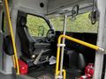 Interior of a 2019 Chevrolet Express with driver's seat visible and yellow handrails along the side