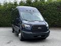 A blue 2017 Ford Transit 350 with a high roof and front grille design featuring a large Ford emblem