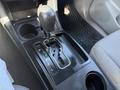 The gear shifter of a 2015 Toyota Tacoma with options for park reverse neutral drive and low gear
