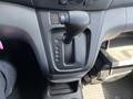 A gear shift console of a 2019 Nissan NV200 with Park Reverse Neutral Drive and Low settings visible