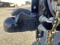 Close-up of the hitch mechanism on a 2024 Southland 18 Foot Dump Trailer featuring a coupler and safety chains