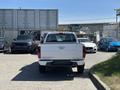 A white 2011 Chevrolet Colorado pickup truck is parked with its rear facing the viewer