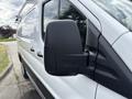 A 2023 Ford Transit with a close-up view of its side mirror and door panel