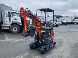 A 2025 AGT Industrial mini excavator with a red arm and black body is positioned for operation with a cab and tracks on a gray surface