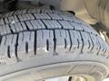 Close-up of a tire with visible tread patterns and slight wear on a 2020 Chevrolet Express