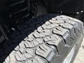 A close-up view of a rugged tire showcasing deep treads of a 2014 Ford F-250 SD