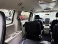 Interior view of a 2017 Dodge Grand Caravan showing black leather seats and a center console with cup holders