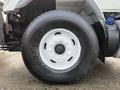 A close-up of the tire and wheel of a 2016 International 7400 featuring a Goodyear tire marked with the model number GF96 and a shiny white rim