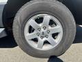 Close-up of a silver alloy wheel from a 2013 Ford Expedition showcasing a five-spoke design and a Goodyear tire with visible treads