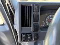 Dashboard controls of a 2012 Isuzu NPR HD featuring air conditioning vents and switches for various vehicle functions