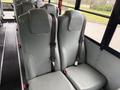 Interior view of a 2016 International CE300 school bus featuring two gray upholstered seats with seat belts