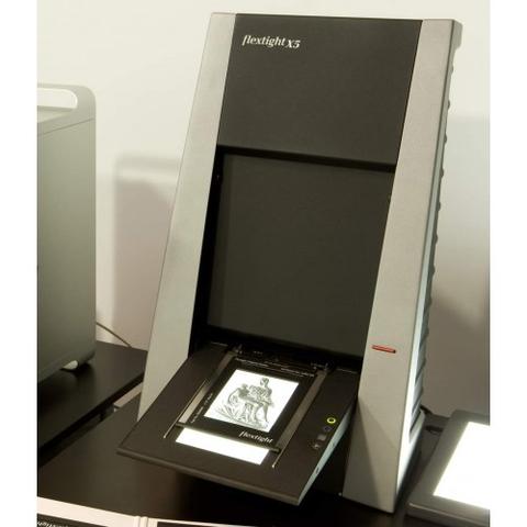 A Hasselblad Flextight X5 photo scanner with a vertical design featuring an opening for scanning images on a flat surface