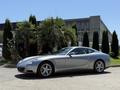 A silver 2005 Ferrari 612 Scaglietti with a sleek design featuring curved lines and five-spoke wheels