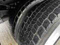 Close-up of the tire tread of a 2015 Ford F-550 showing deep grooves and a rugged design for traction and stability