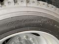 Close-up of a tire with the size designation 225/70R19.5 and the inscription MADE IN CHINA on the sidewall