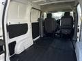 Interior view of a 2017 Nissan NV200 showing the cargo area with gray floor and walls and two front seats visible in the background