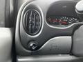 Dashboard of a 2004 Ford Econoline showing ventilation controls and instrument cluster with speedometer and other gauges