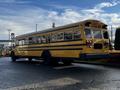 2005 Blue Bird 48 passenger bus with a yellow exterior and black accents displaying the words SCHOOL BUS on the back