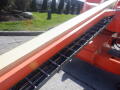 A 2008 JLG Boom Lift with an extended arm featuring a metal track and white platform ready for elevation