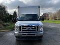 Front view of a 2021 Ford Econoline with a silver grille and white box cargo area