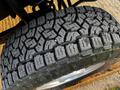 Close-up of a rugged tire from a 2012 Ford F-250 showcasing a detailed tread pattern designed for traction and durability