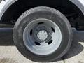 Close-up of a 2008 Ford F-550 wheel showing the grey rim and tire tread with the brand name visible on the sidewall
