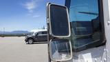 A 2006 Ford Econoline with side mirrors reflecting the surroundings and a clear view through the front window