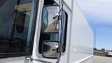 A 2011 Ford Econoline with chrome side mirrors and a white exterior viewed from the front passenger side