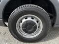 A close-up view of a 2018 Ford Transit wheel featuring a silver rim and a black tire with visible tread patterns