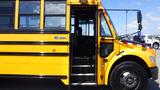 A 2014 Freightliner Thomas Diesel school bus with an open door and steps leading inside