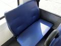 A blue upholstered seat inside a vehicle with a smooth texture and clear lines