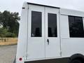A white 2020 Chevrolet Express with two large side doors and a blue wheelchair accessibility symbol on the side