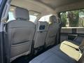 Interior view of the back seat of a 2018 Ford F-150 with two headrests and a center console. The seats are covered in gray fabric with a textured pattern