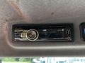 A JVC car stereo mounted on a vehicle dashboard with a USB port and various buttons for control