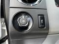 A control panel in a 2016 Ford F-550 featuring a dial for headlight settings and a button for fog lights