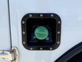 A diesel fuel filler cap with a green label indicating its diesel fuel type on a 2023 Ford F-550