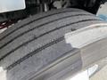 A close-up of a tire from a 2022 International MV607 showing detailed tread patterns and wear marks on the rubber surface