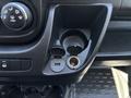 Dashboard console of a 2016 RAM Promaster featuring a USB port and a power outlet alongside climate control knobs