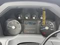 The dashboard of a 2011 Ford F-650 showing gauges for RPM speed and fuel levels with a digital screen displaying trip details and mileage