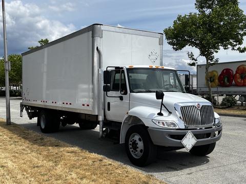 A 2019 International 4300 truck with a white box cargo area and a silver front section parked on a paved surface.