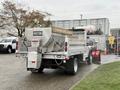 A 2021 Ford F600 truck with a salt spreader attachment mounted on the rear and a snow plow in the front