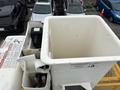 A white utility bucket on a 2015 Freightliner M2 106 with safety labels and controls visible inside the bucket