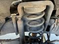 The underside of a 2016 Ford F-250 SD showing a suspension spring and exhaust components