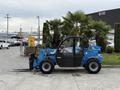 A blue 2020 Genie GTH-5519 telehandler with a black enclosed cab and forks attached to the front