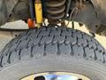 Close-up of a tire from a 2015 Ford F-450 SD showcasing deep tread patterns designed for traction and stability on various terrains