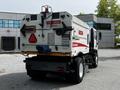 A 2012 Autocar Xpert rear view with warning signs and a message instructing caution and visibility around the vehicle