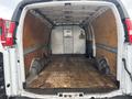 Empty cargo area of a 2022 GMC Savana with wooden flooring and side panels