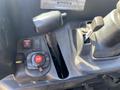 Close-up of the control panel of a 2018 Kubota RTV-X 1100 C featuring gear shifters buttons and a key ignition switch